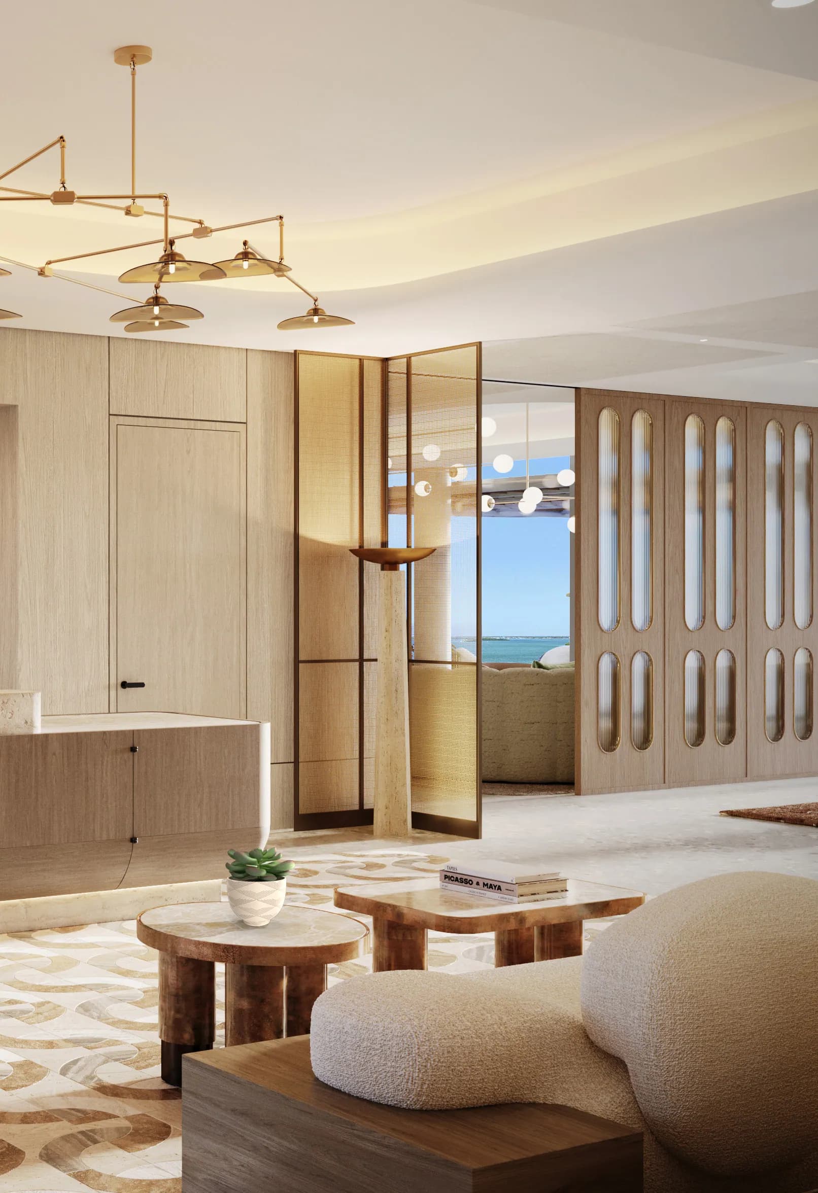 Arrival foyer with the brass mobile chandelier and pivoting bronze screen