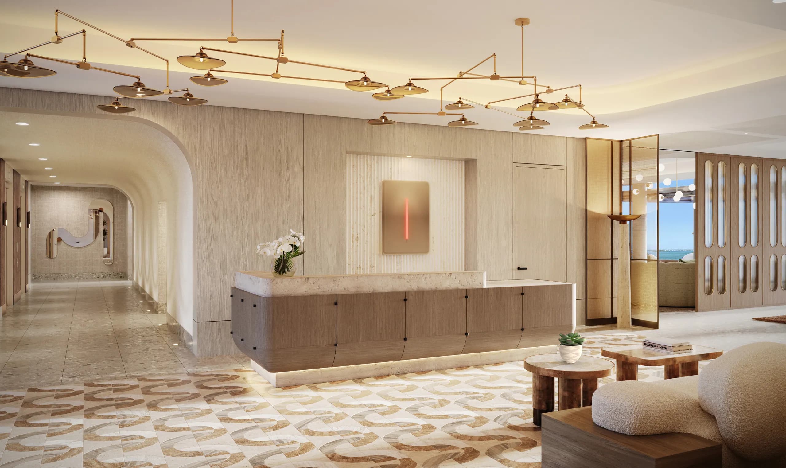 Travertine reception desk beneath the brass mobile