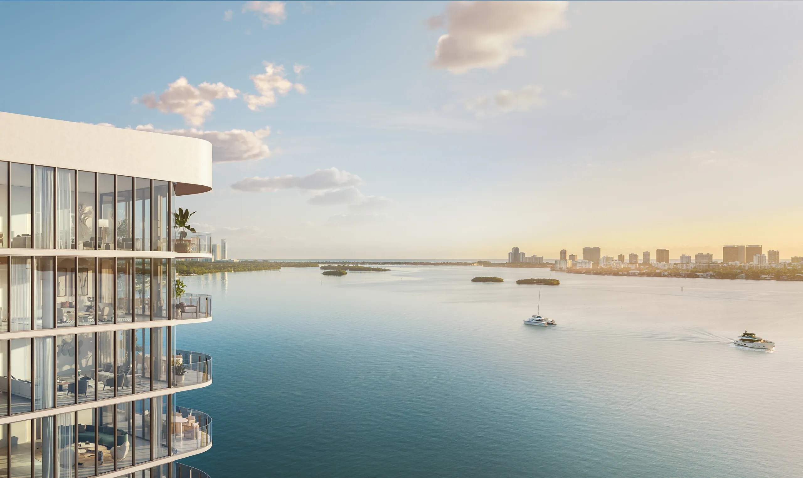 Solana Bay's glass tower over the calm bay at sunset, sailboats beyond