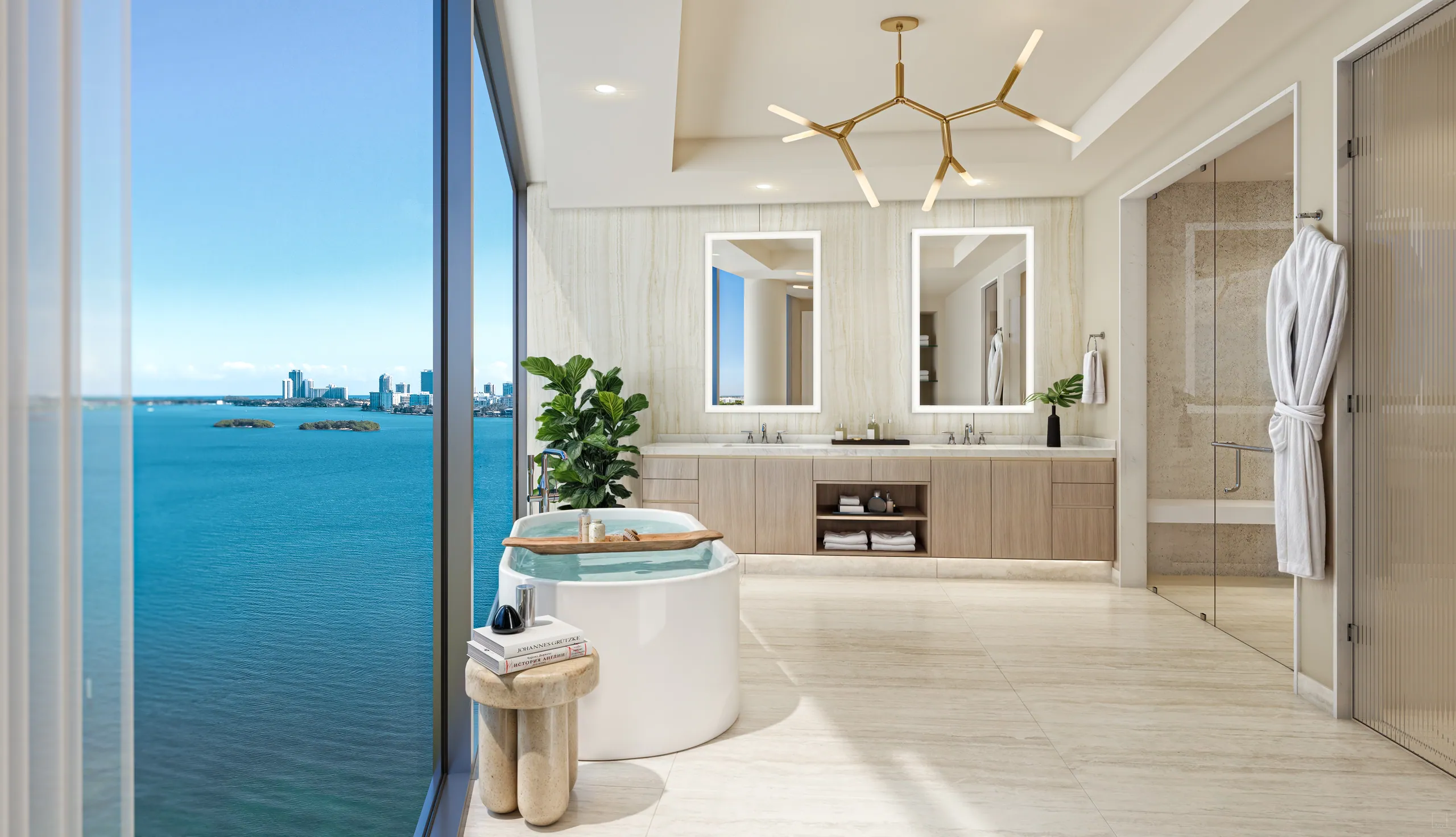 Primary bath with twin lit mirrors, brass branch chandelier and soaking tub