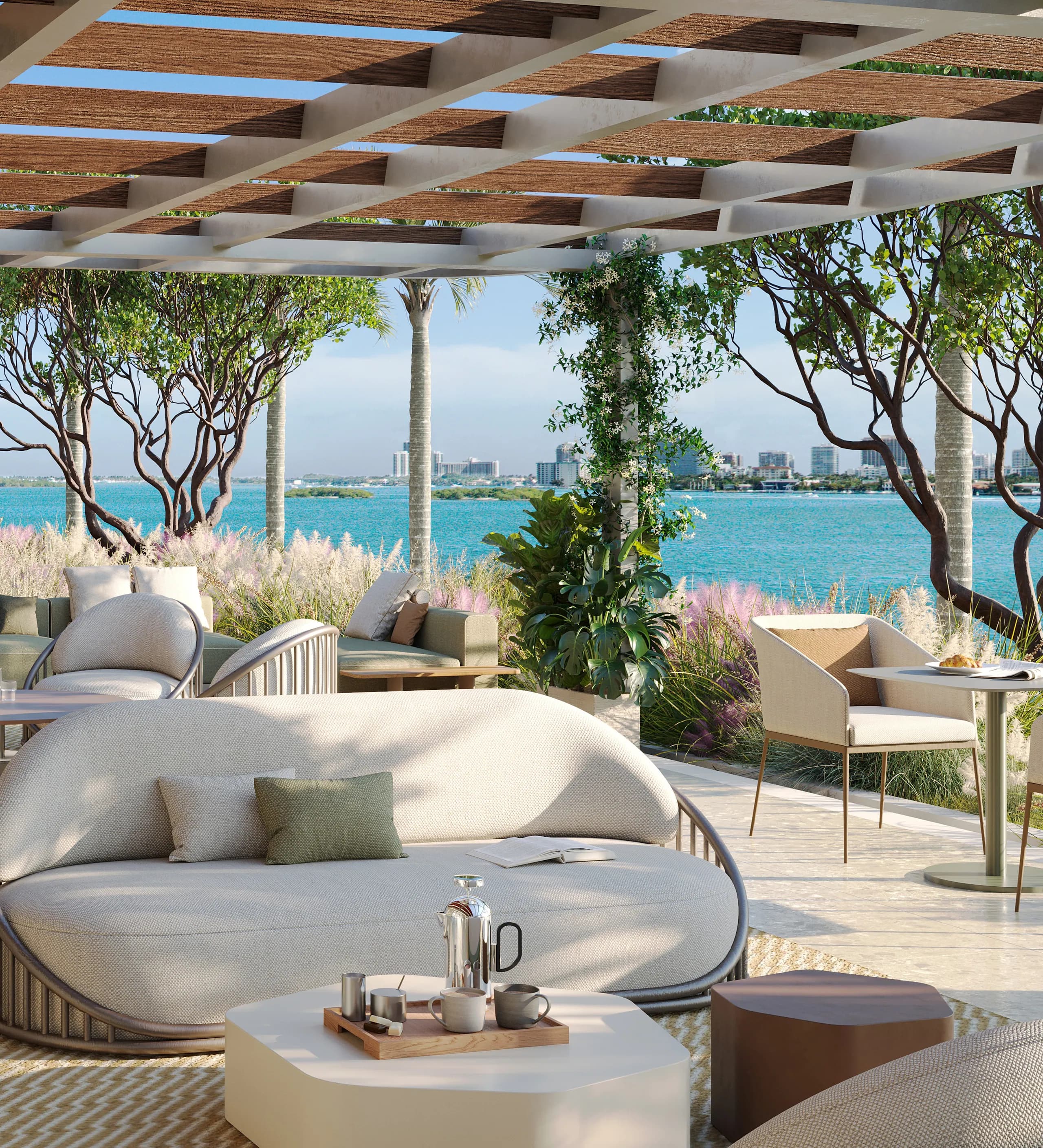 Slatted-pergola terrace lounge with a round daybed over the turquoise bay